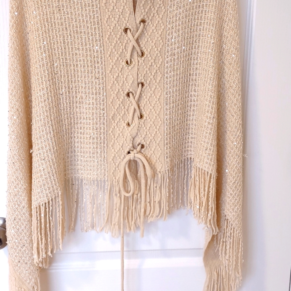 Festive knitted poncho in shimmering cream. Holiday Savings!
